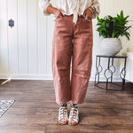 Light copper denim barrel style jeans with ankle length and twisted seam detail on the sides.