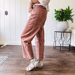 Light copper denim barrel style jeans with ankle length and twisted seam detail on the sides.