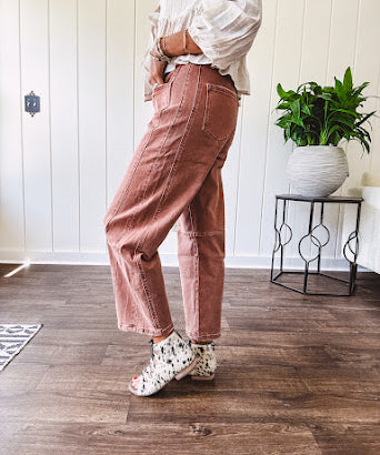 Light copper denim barrel style jeans with ankle length and twisted seam detail on the sides.