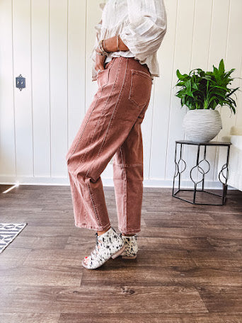 Light copper denim barrel style jeans with ankle length and twisted seam detail on the sides.