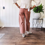 Light copper denim barrel style jeans with ankle length and twisted seam detail on the sides.