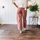 Light copper denim barrel style jeans with ankle length and twisted seam detail on the sides.