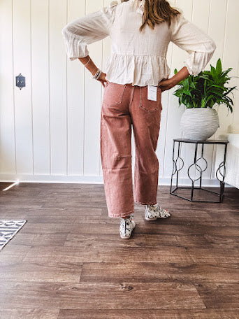 Light copper denim barrel style jeans with ankle length and twisted seam detail on the sides.