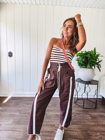 Ribbed texture stretchy tube top with gathering at the bust and cropped hem.