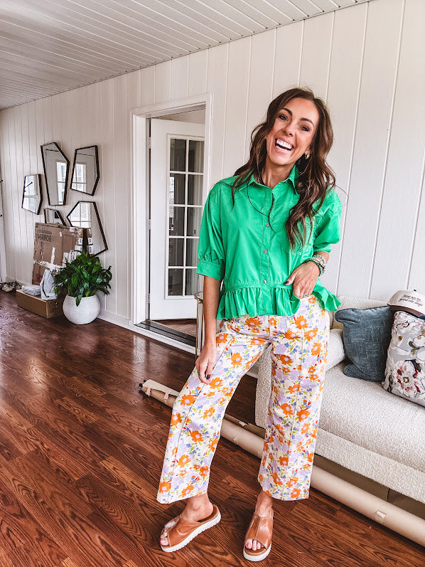 Cotton button and zipper closure bright floral pants with seams down the front of both legs and front and back 