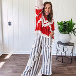 Wide leg cotton oversized gray and white striped pants with elastic back, button and zipper closure and crochet patch detail throughout.