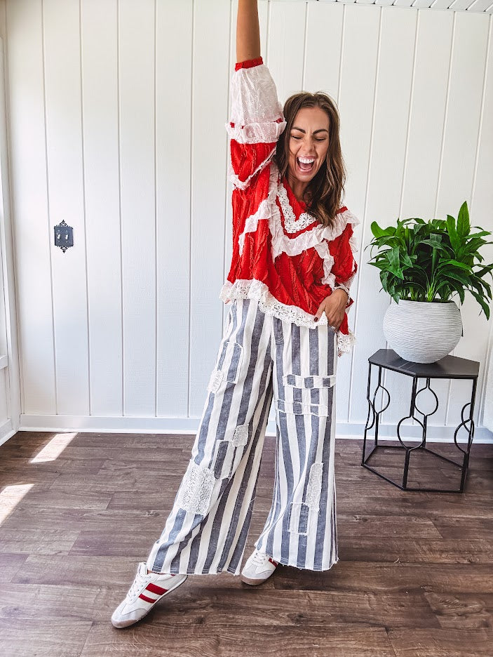 Wide leg cotton oversized gray and white striped pants with elastic back, button and zipper closure and crochet patch detail throughout.