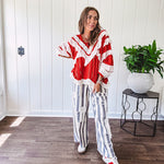 Wide leg cotton oversized gray and white striped pants with elastic back, button and zipper closure and crochet patch detail throughout.