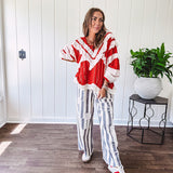 Wide leg cotton oversized gray and white striped pants with elastic back, button and zipper closure and crochet patch detail throughout.