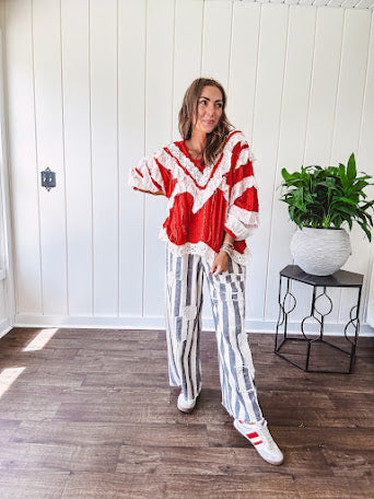 Wide leg cotton oversized gray and white striped pants with elastic back, button and zipper closure and crochet patch detail throughout.