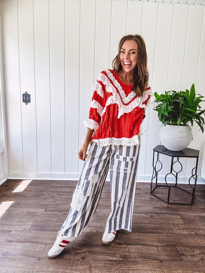 Wide leg cotton oversized gray and white striped pants with elastic back, button and zipper closure and crochet patch detail throughout.