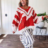 Apple red ruffle texture boho style long sleeved top with round neck and cream eyelet lace detail in a V shape across the front and on the sleeves and hem.