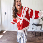 Apple red ruffle texture boho style long sleeved top with round neck and cream eyelet lace detail in a V shape across the front and on the sleeves and hem.