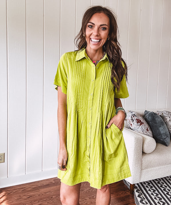 Chartreuse short sleeved button down dress, mini length with pintuck detail in front and pockets.