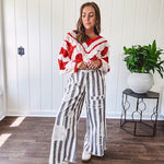 Wide leg cotton oversized gray and white striped pants with elastic back, button and zipper closure and crochet patch detail throughout.