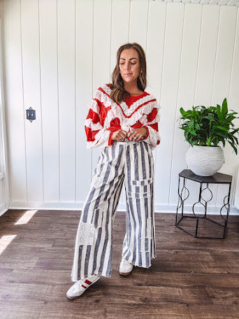 Wide leg cotton oversized gray and white striped pants with elastic back, button and zipper closure and crochet patch detail throughout.