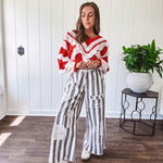 Wide leg cotton oversized gray and white striped pants with elastic back, button and zipper closure and crochet patch detail throughout.