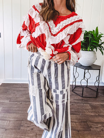 Wide leg cotton oversized gray and white striped pants with elastic back, button and zipper closure and crochet patch detail throughout.