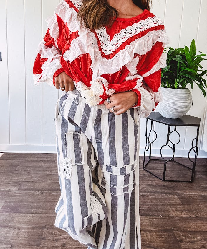 Wide leg cotton oversized gray and white striped pants with elastic back, button and zipper closure and crochet patch detail throughout.