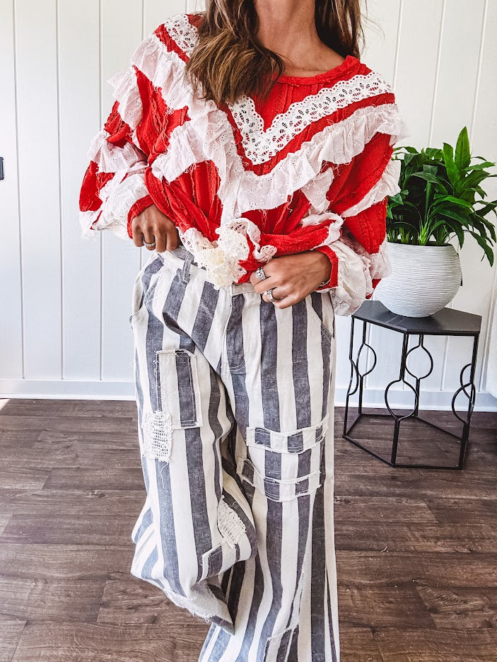 Wide leg cotton oversized gray and white striped pants with elastic back, button and zipper closure and crochet patch detail throughout.