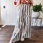 Wide leg cotton oversized gray and white striped pants with elastic back, button and zipper closure and crochet patch detail throughout.