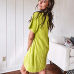 Chartreuse short sleeved button down dress, mini length with pintuck detail in front and pockets.