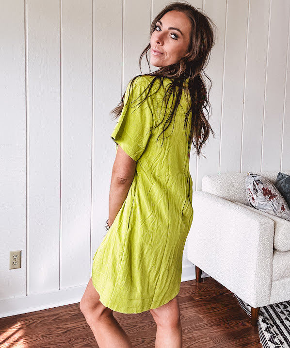 Chartreuse short sleeved button down dress, mini length with pintuck detail in front and pockets.