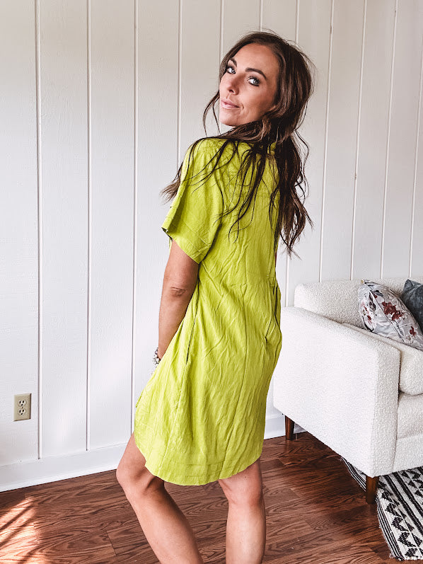 Chartreuse short sleeved button down dress, mini length with pintuck detail in front and pockets.