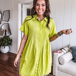 Chartreuse short sleeved button down dress, mini length with pintuck detail in front and pockets.
