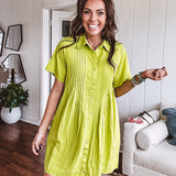 Chartreuse short sleeved button down dress, mini length with pintuck detail in front and pockets.