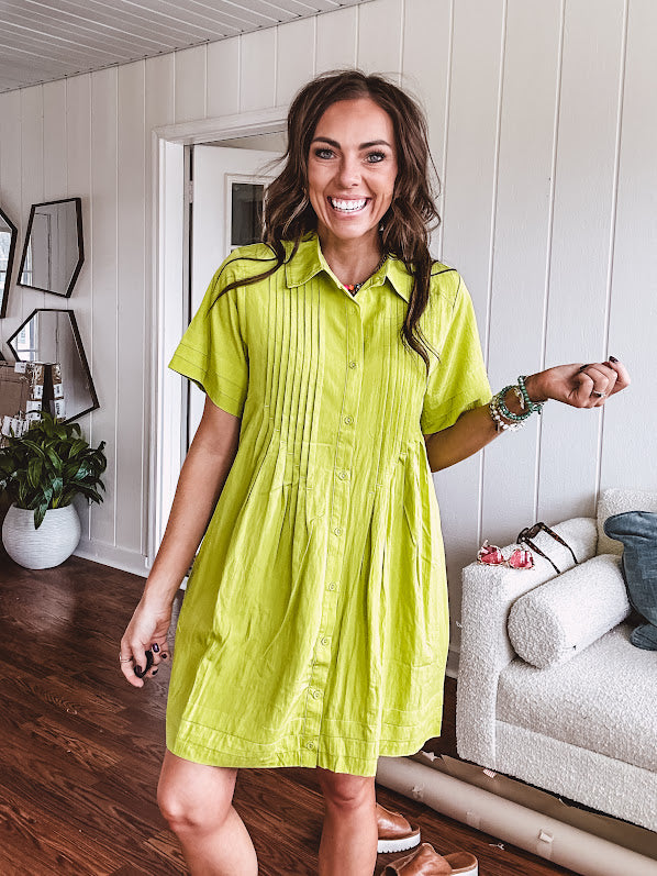 Chartreuse short sleeved button down dress, mini length with pintuck detail in front and pockets.