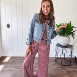 Medium wash non-stretch denim jacket with classic trim, raw, uneven hem and cuffs with silver hardware and cropped length.