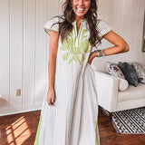 Sage and white striped midi length dress with short sleeves, mock collar, V neck and sage floral embroidery at the yoke and sage trim with side slits.