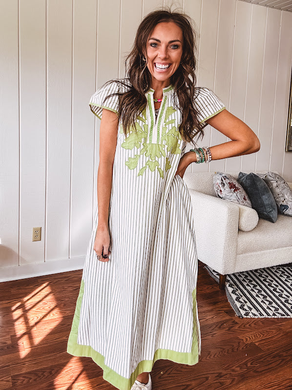Sage and white striped midi length dress with short sleeves, mock collar, V neck and sage floral embroidery at the yoke and sage trim with side slits.