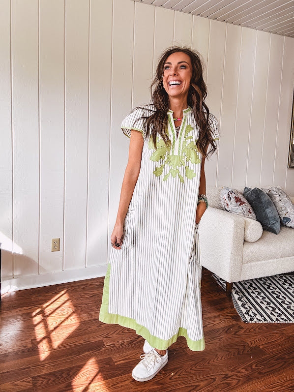 Sage and white striped midi length dress with short sleeves, mock collar, V neck and sage floral embroidery at the yoke and sage trim with side slits.