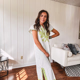 Sage and white striped midi length dress with short sleeves, mock collar, V neck and sage floral embroidery at the yoke and sage trim with side slits.