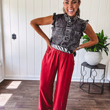 Washed black denim vest with ruffles at collar and sleeves, front pockets and silver buttons down the front.