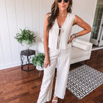 Natural colored linen pants with a button and zipper closure, elastic back, classic fit and shorts lining with black pin stripes.