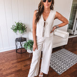 Natural colored linen pants with a button and zipper closure, elastic back, classic fit and shorts lining with black pin stripes.