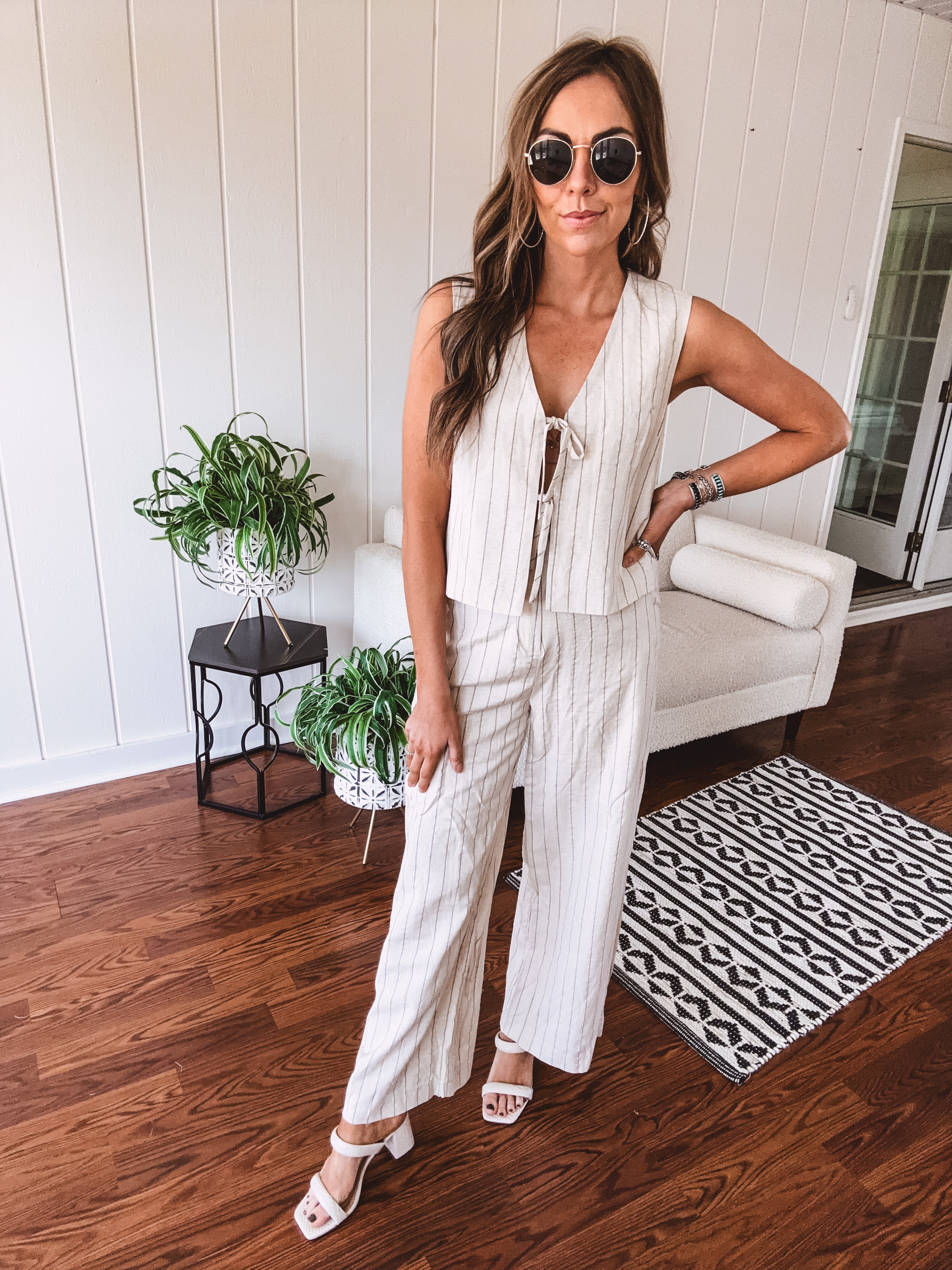 Natural colored linen pants with a button and zipper closure, elastic back, classic fit and shorts lining with black pin stripes.