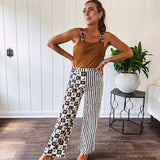 Wide leg lightweight button and zipper closure pants with elastic back waist featuring cream and black stripes down one leg and moon and star checkerboard in black, cream and mustard on the other leg.