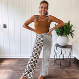 Wide leg lightweight button and zipper closure pants with elastic back waist featuring cream and black stripes down one leg and moon and star checkerboard in black, cream and mustard on the other leg.