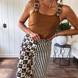 Camel colored ribbed textured bodysuit with snap closure and silver western buckle adjustable shoulder straps with square neckline.