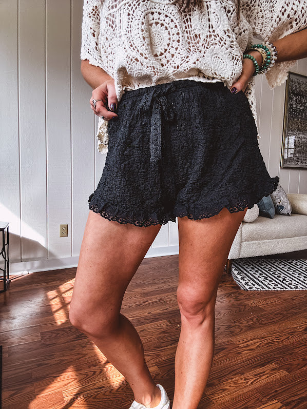 Relaxed fit, bubble texture, eyelet trim, drawstring waist shorts available in almond/ivory or black.