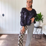 Black long sleeved blouse with lace and eyelet ruffle detail throughout.