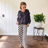 Black long sleeved blouse with lace and eyelet ruffle detail throughout.