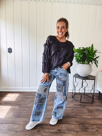 Medium wash denim wide leg pants with washed black, black and white stripe and denim patchwork detail throughout.