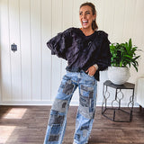 Medium wash denim wide leg pants with washed black, black and white stripe and denim patchwork detail throughout.