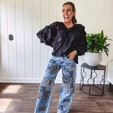 Medium wash denim wide leg pants with washed black, black and white stripe and denim patchwork detail throughout.
