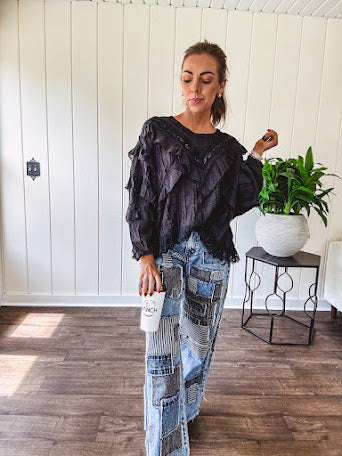Medium wash denim wide leg pants with washed black, black and white stripe and denim patchwork detail throughout.